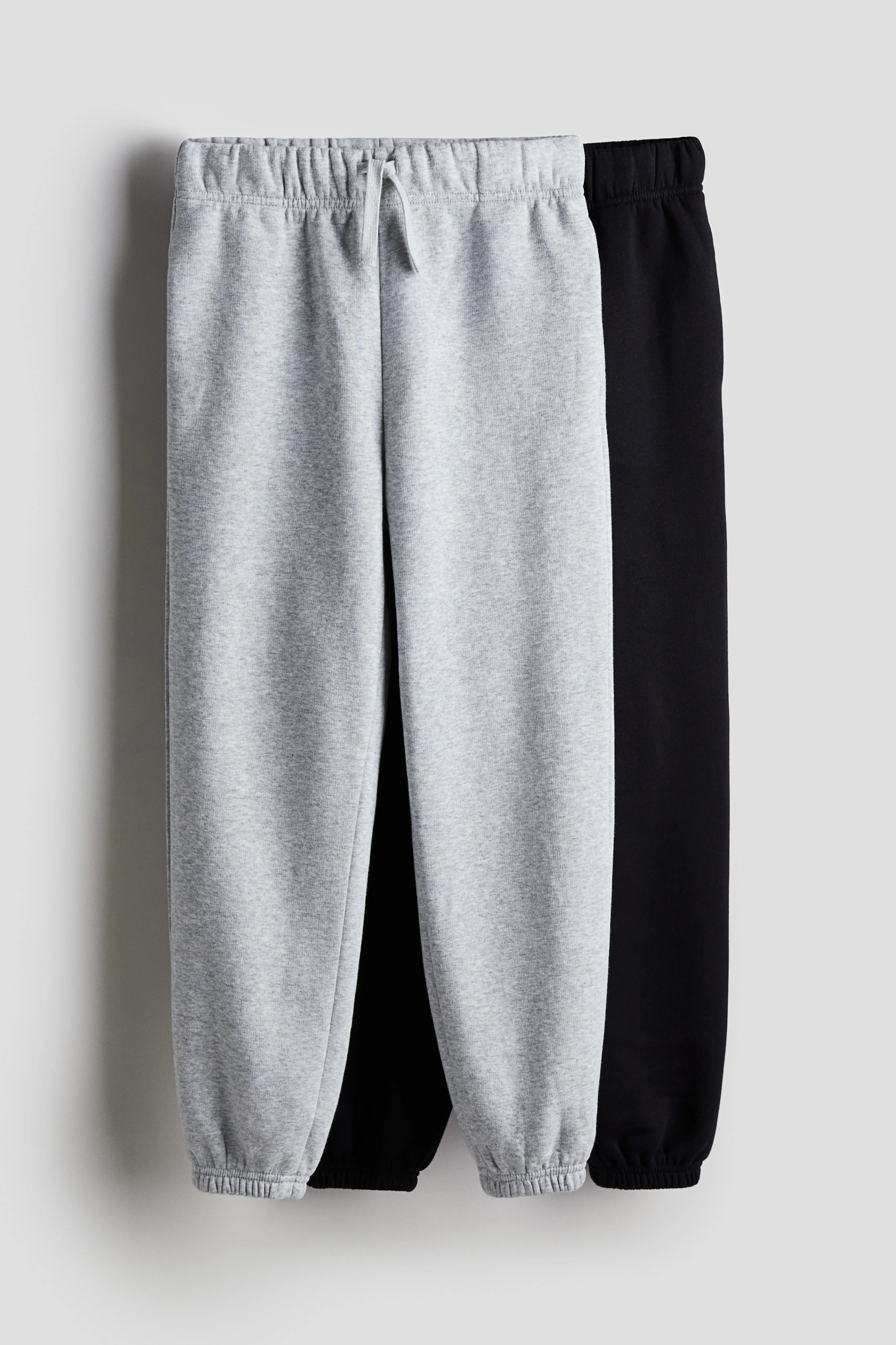 2-pack Loose Fit sweatshirt joggers - Regular waist - Extra-long legs - Black/Light grey marl - Kids | H&M GB