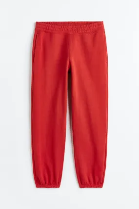 Relaxed Fit Cotton joggers - Regular waist - Long - Crimson red - Men | H&M GB